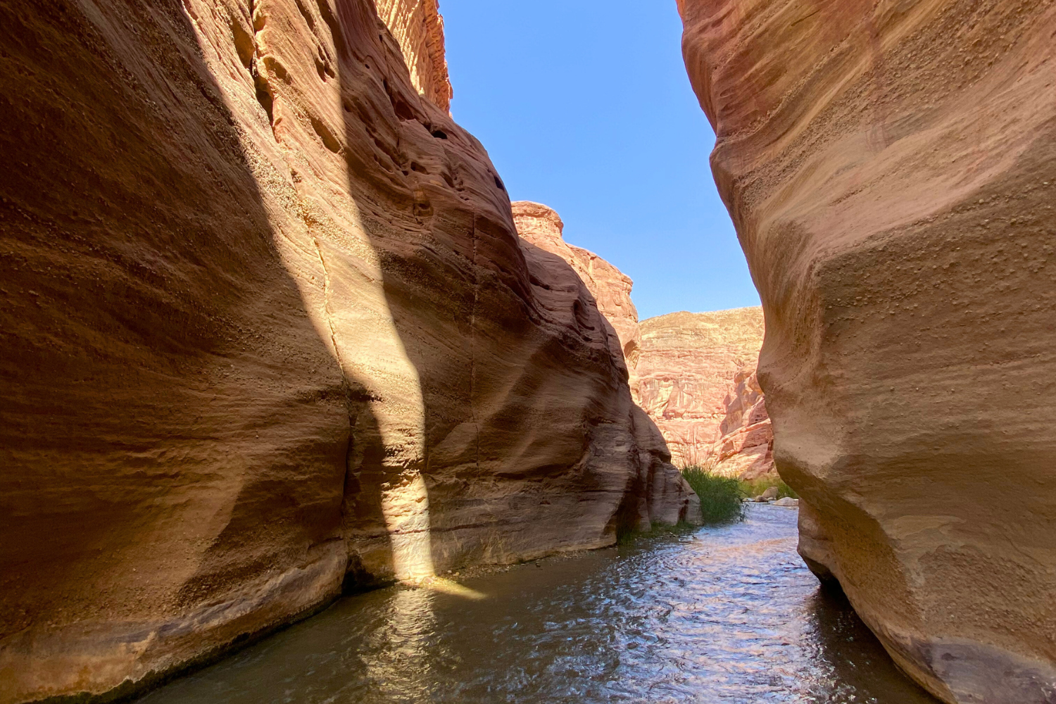 Stream flowing through towering rock formations in Jordan