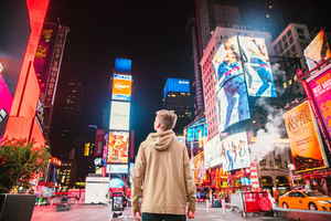 Traveller looking up in Times Square, New York, United States