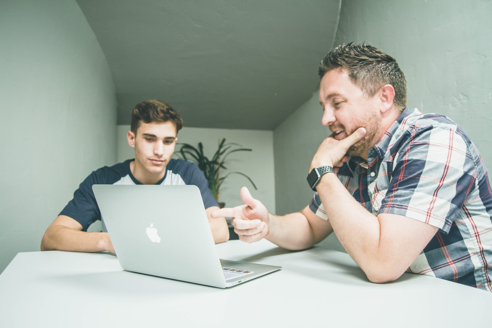 Parent and young adult planning for travels on a laptop