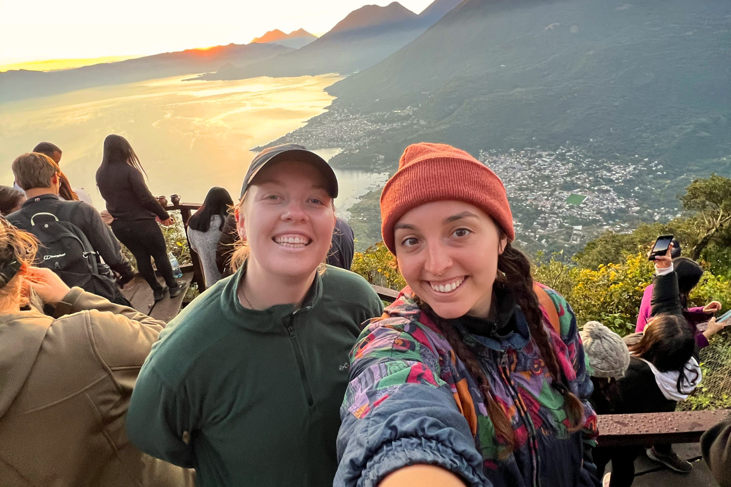 Two travellers taking a selfie at Lake Atitlan viewpoint at sunset in Guatemala in Central America