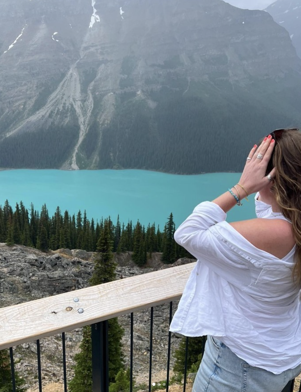 Traveller looking across lake in Canada