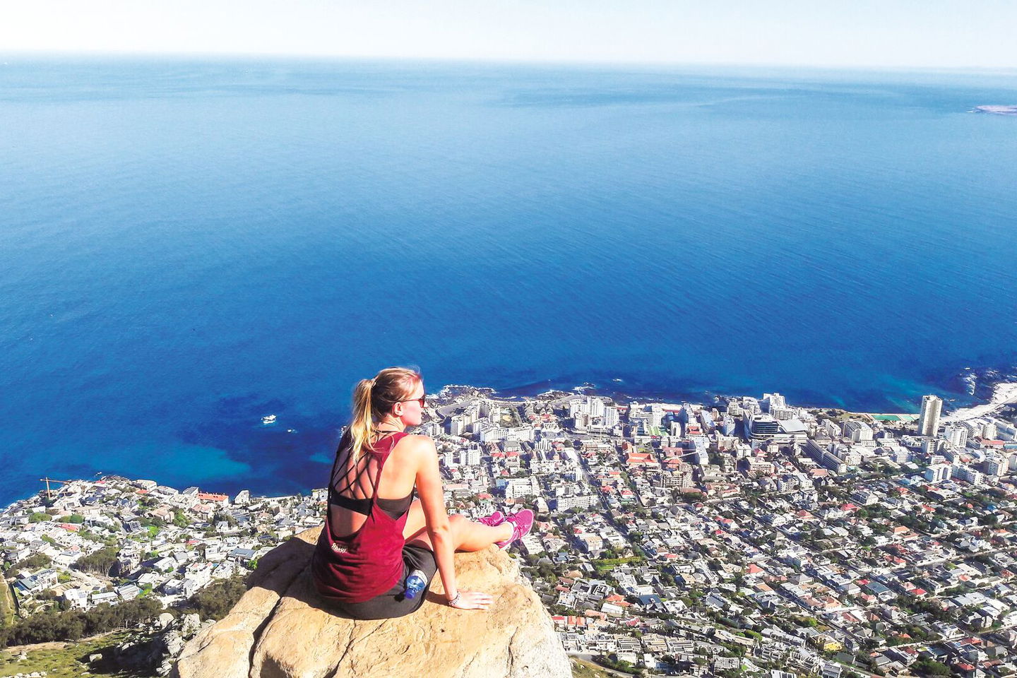 Woman sat on ledge over cape town in south africa