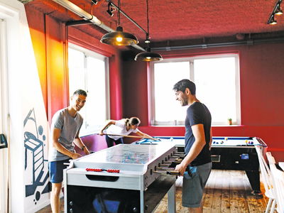 Backpackers playing pool in hostel in europe