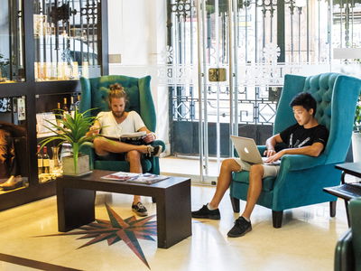 People chilling in common area in south america hotel