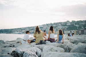 Group watching the sunset in Napoli, Italy