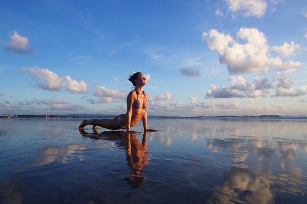 Girl on bali beach doing yoga