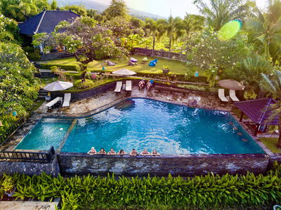 Group of 18-30s travellers in infinity pool near accommodation in Lovina, Bali Indonesia