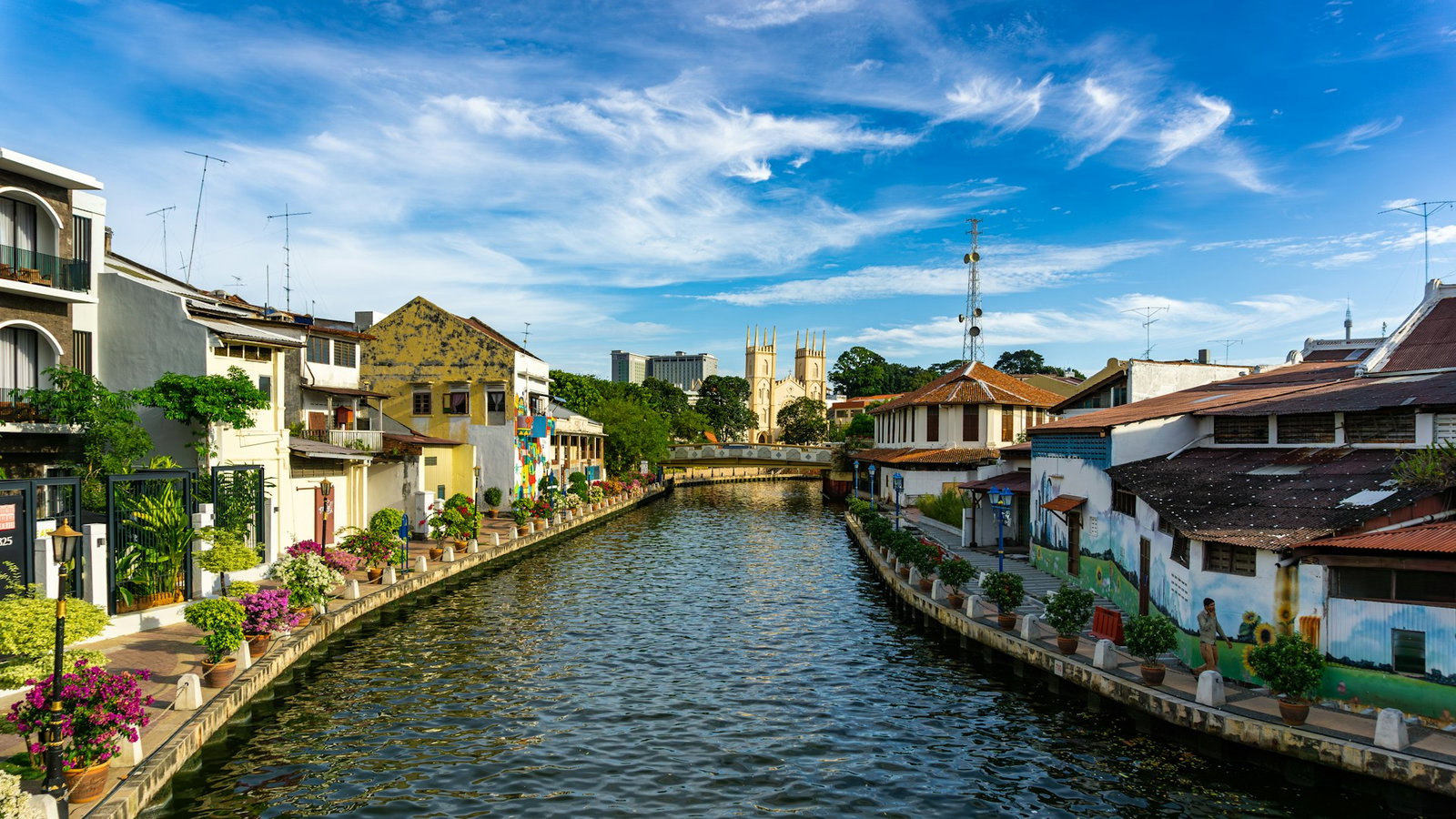 Waterfront of Malacca with colourful rural houses and river running through on a clear day with blue skies