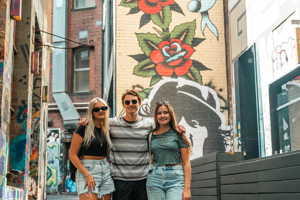 group travellers in graffiti street in melbourne