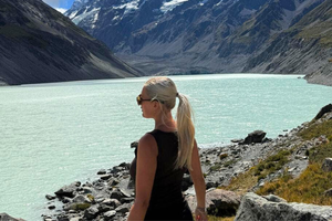 Solo woman traveller looking out to view in Mount Cook National Park in New Zealand