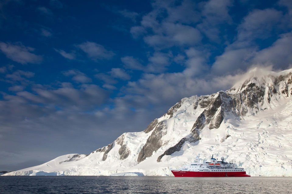 antarctica expedition ship with icebergs