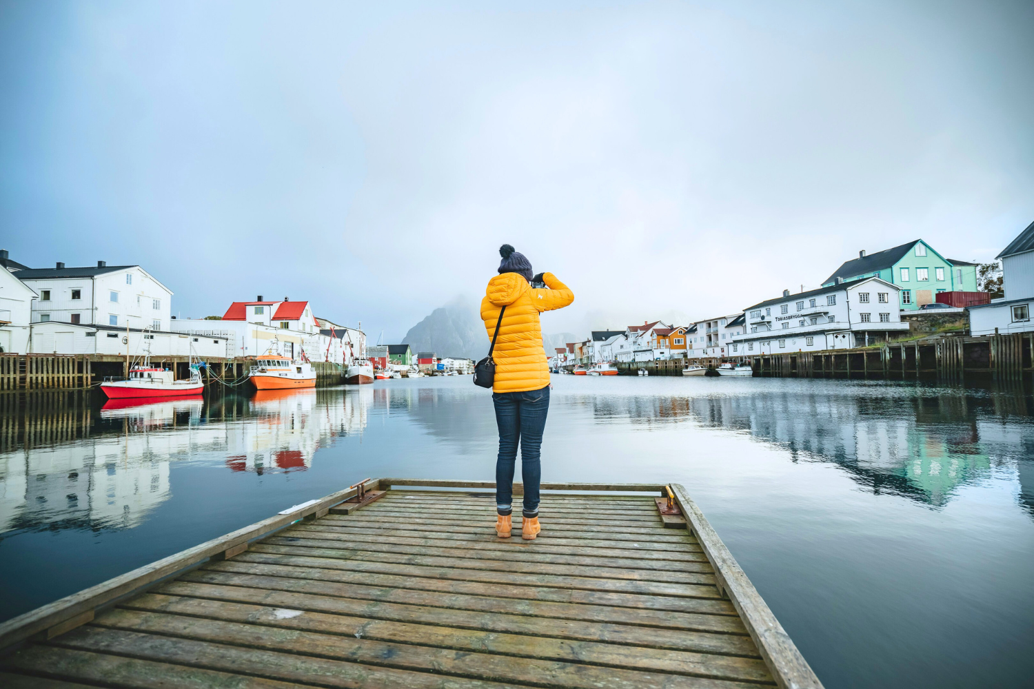 Traveller taking a photo from dock in Norway