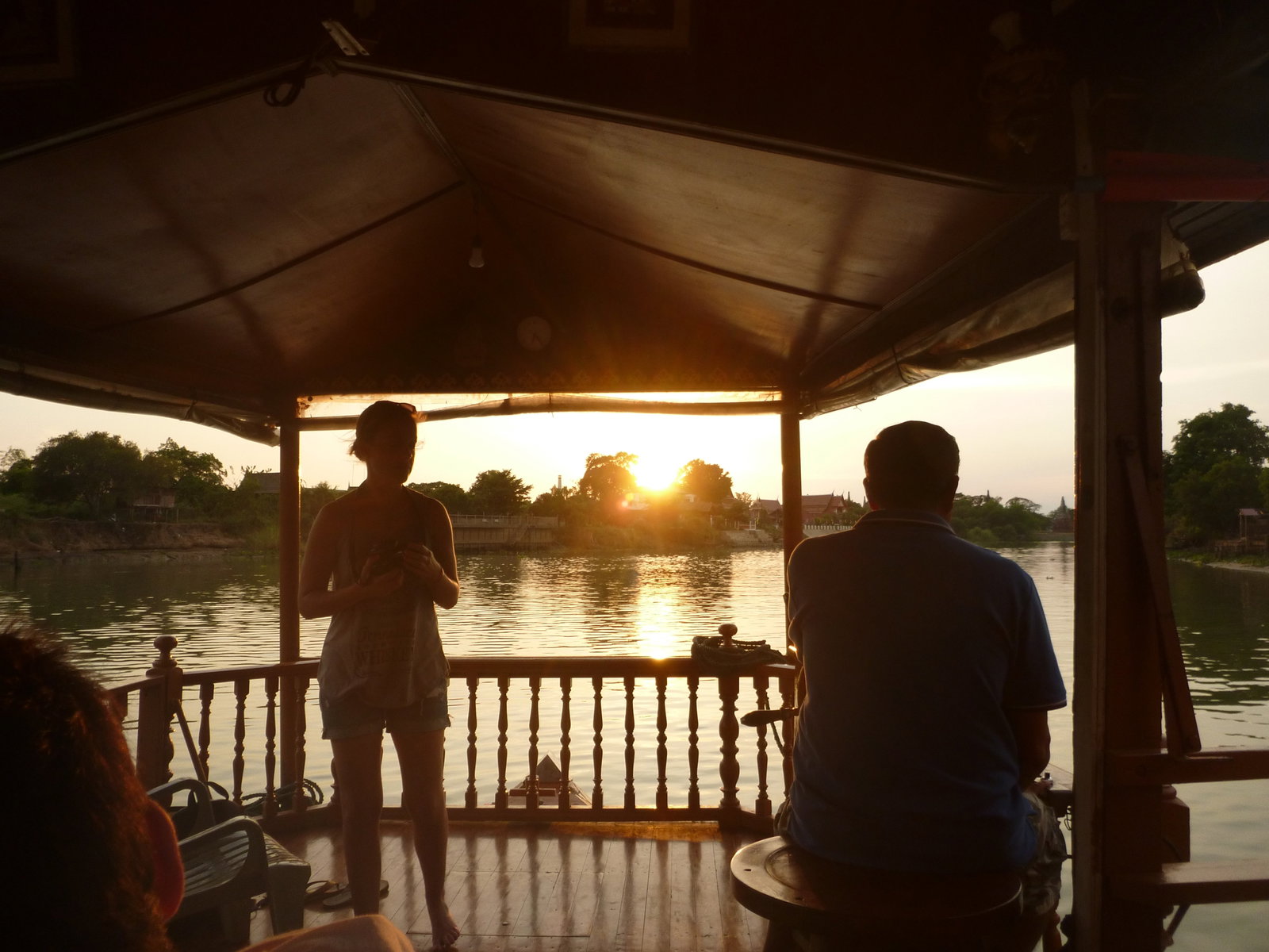 Two travellers sitting in a hut on the water in Thailand
