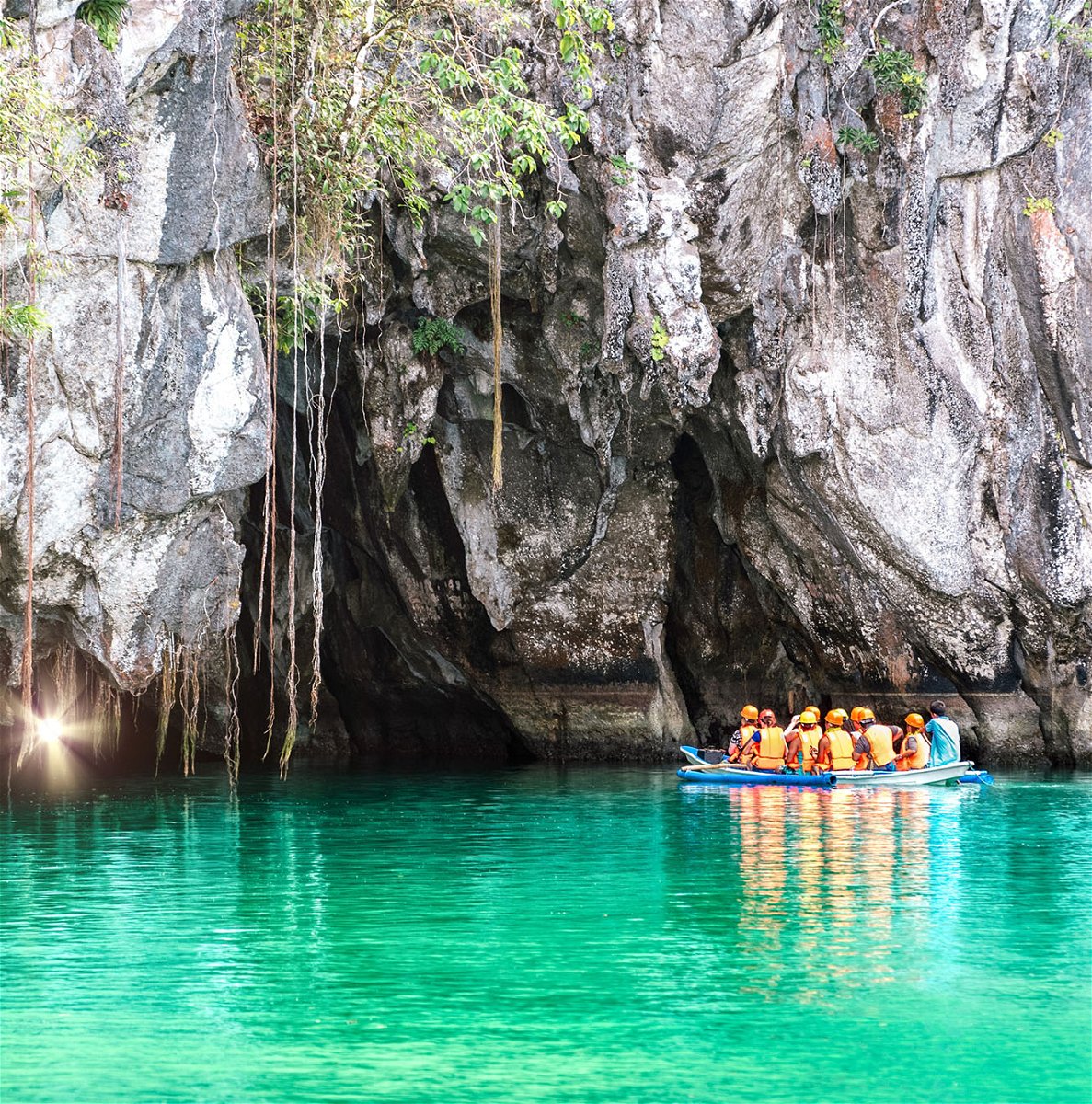 Travellers on boat at underground river in Palawan