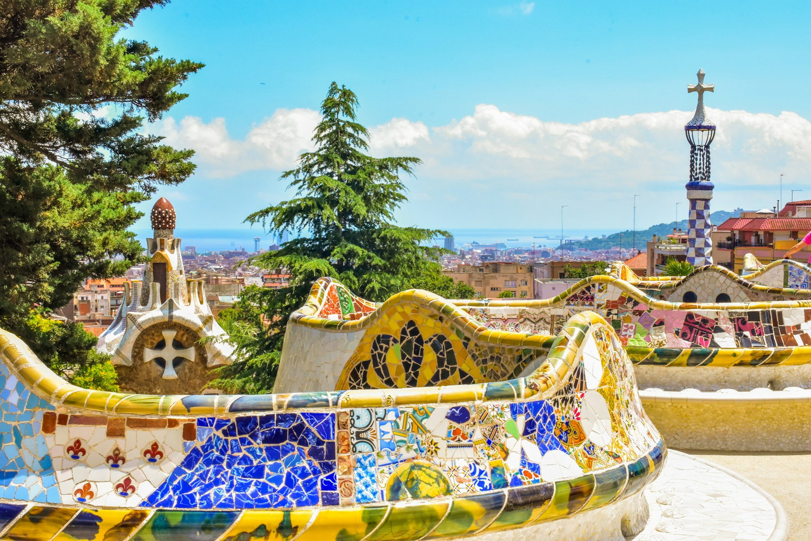 Colourful balcony bridge in Park Guell, overlooking Barcelona and the ocean