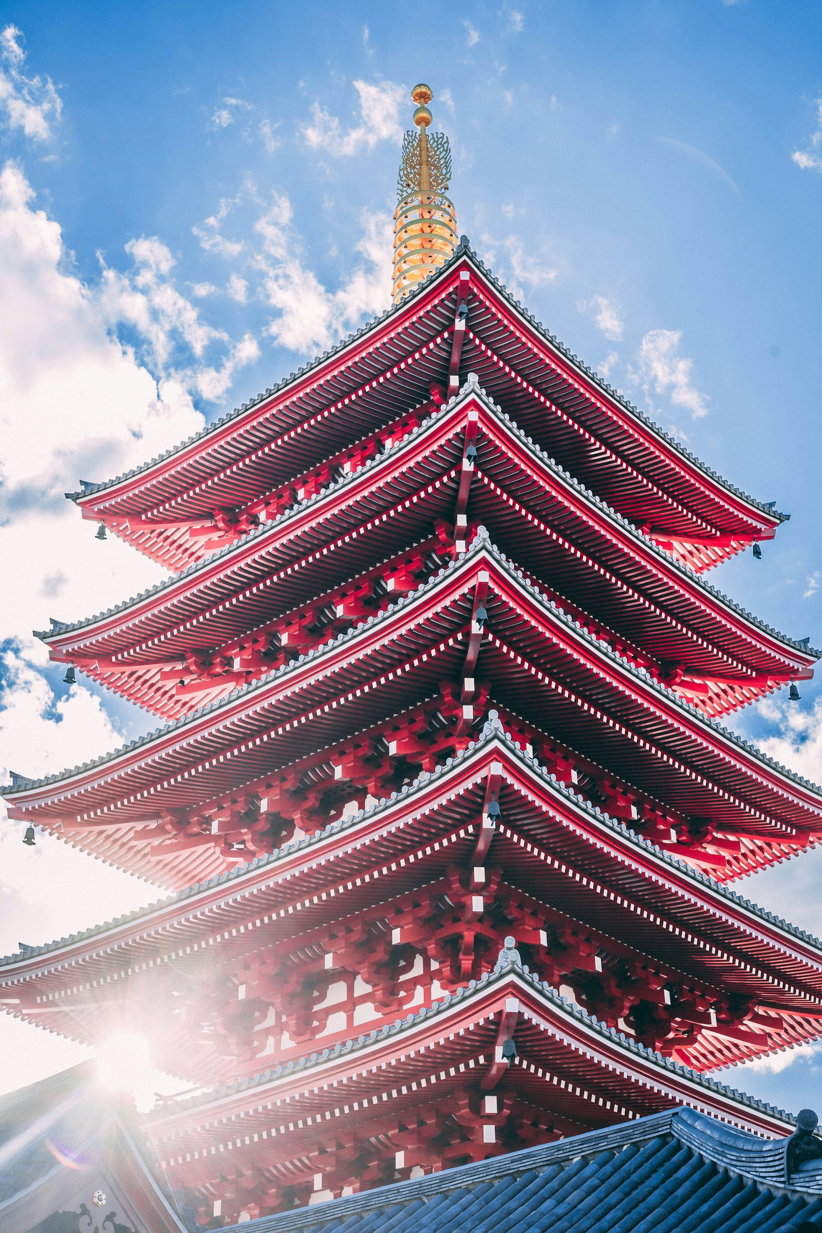 Japanese red pagoda with blue sky and golden top