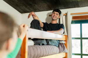 Person sitting on hostel bunk bed