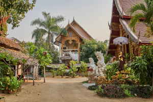 A dirt road between golden temples in Thailand