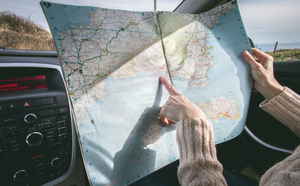 Person looking at a map in a car