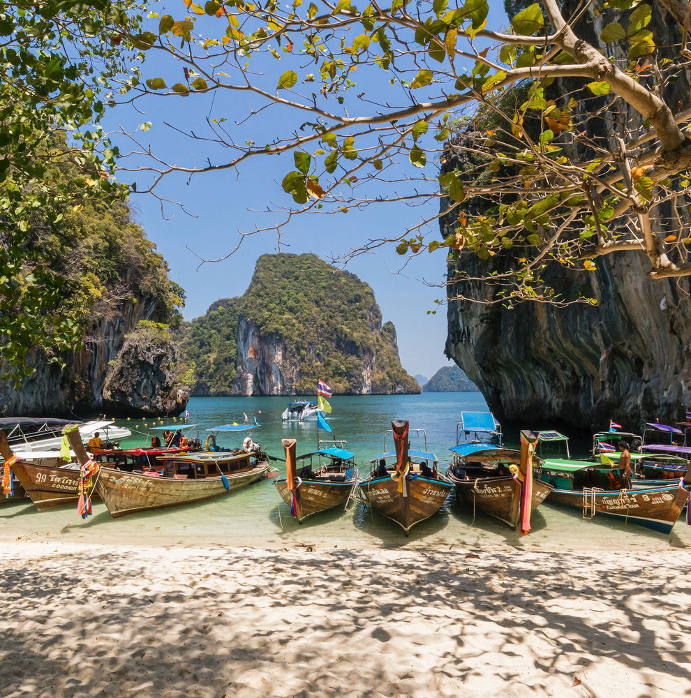 Long-tail boats on beach in Thailand
