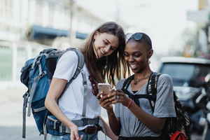 Two travellers looking at phone