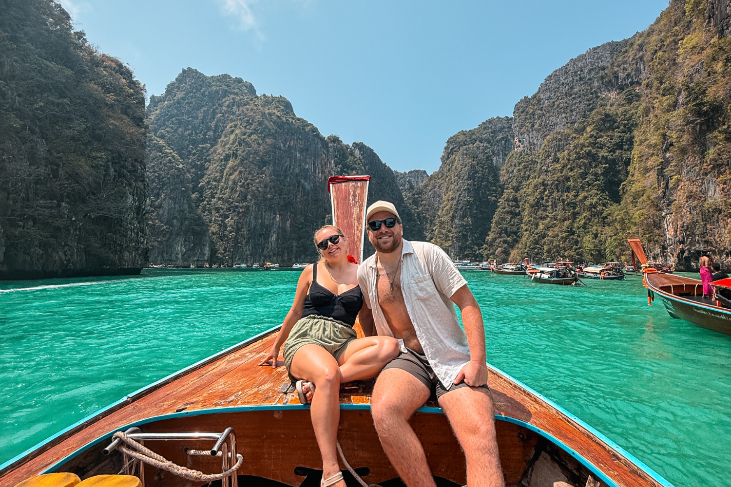 Two travellers on a long tail boat around the Phi Phi islands in Thailand