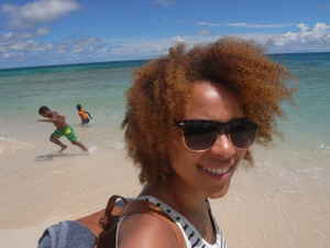 Shakia on the beach with kids playing in the background