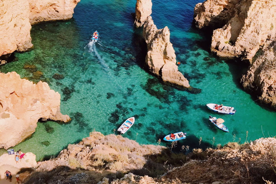 Blue lagoon with boats and rocks