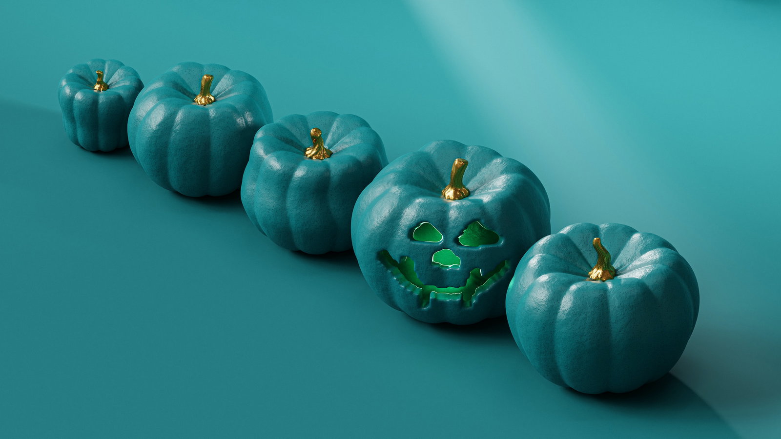 A row of teal-coloured pumpkins, with one carved as a jack-o-lantern