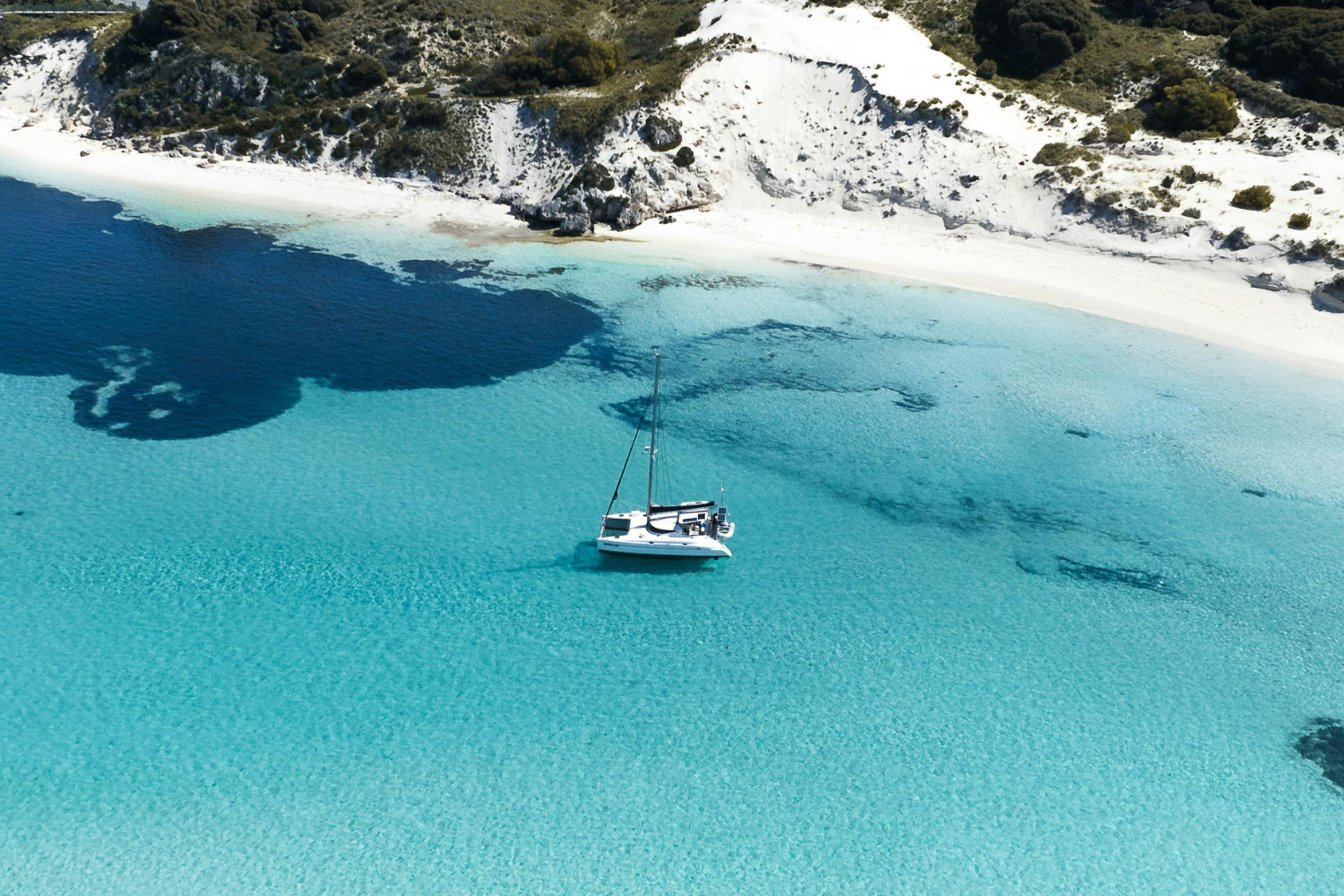Boat in crystal clear water off the shores of Rottnest Island, near Perth in Australia