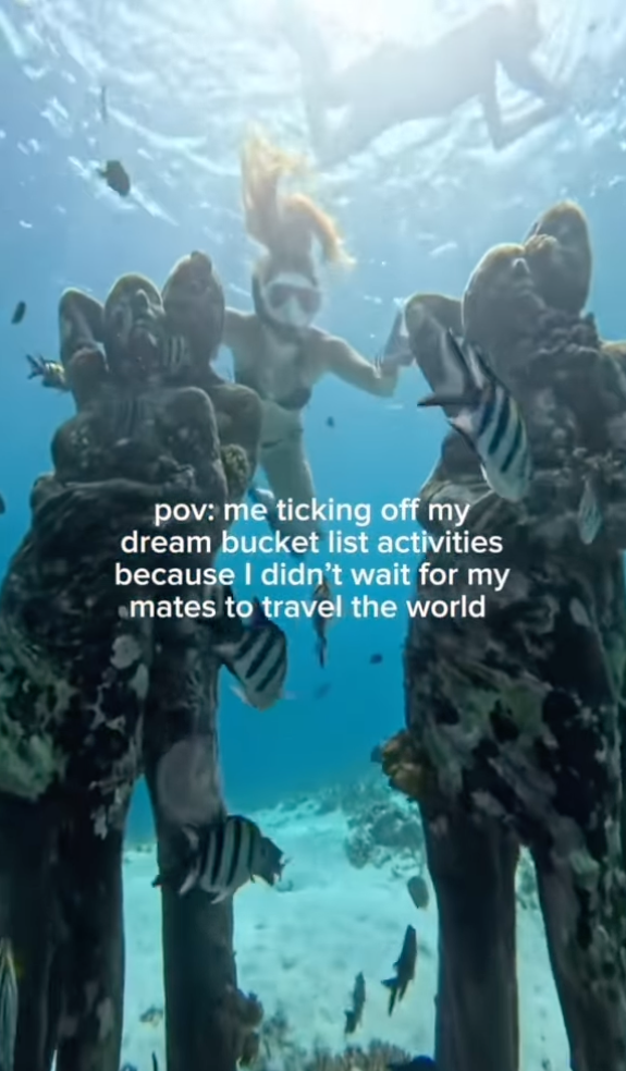 Travellers swimming by underwater statues in Gili Trawangan