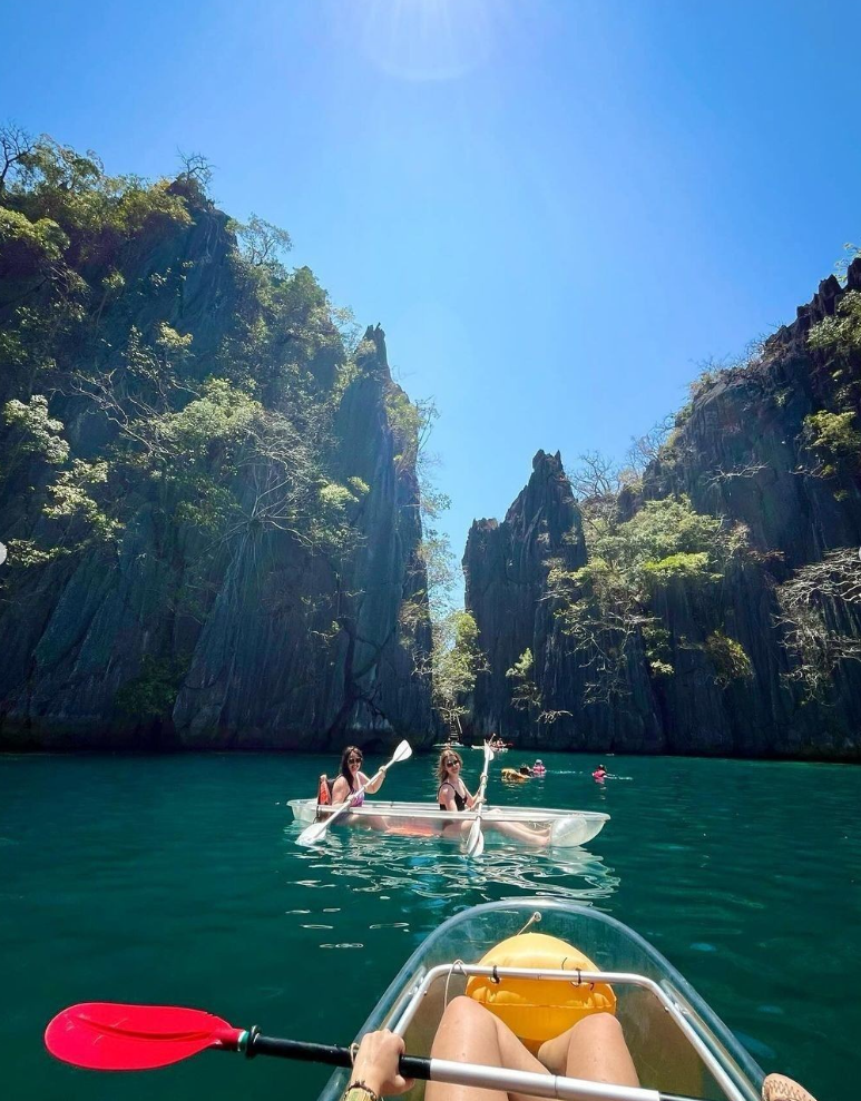 Traveller kayaking in the water in the Philippines