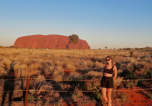 Traveller in front of Uluru in Australia's Northern Territory at Sunset