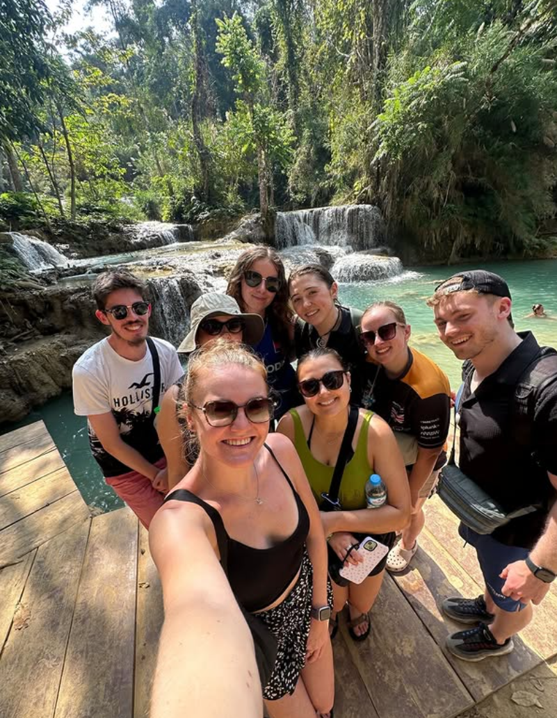Travellers taking selfie at waterfall in Southeast Asia