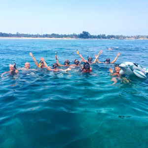 A group of travellers with scuba gear in the water