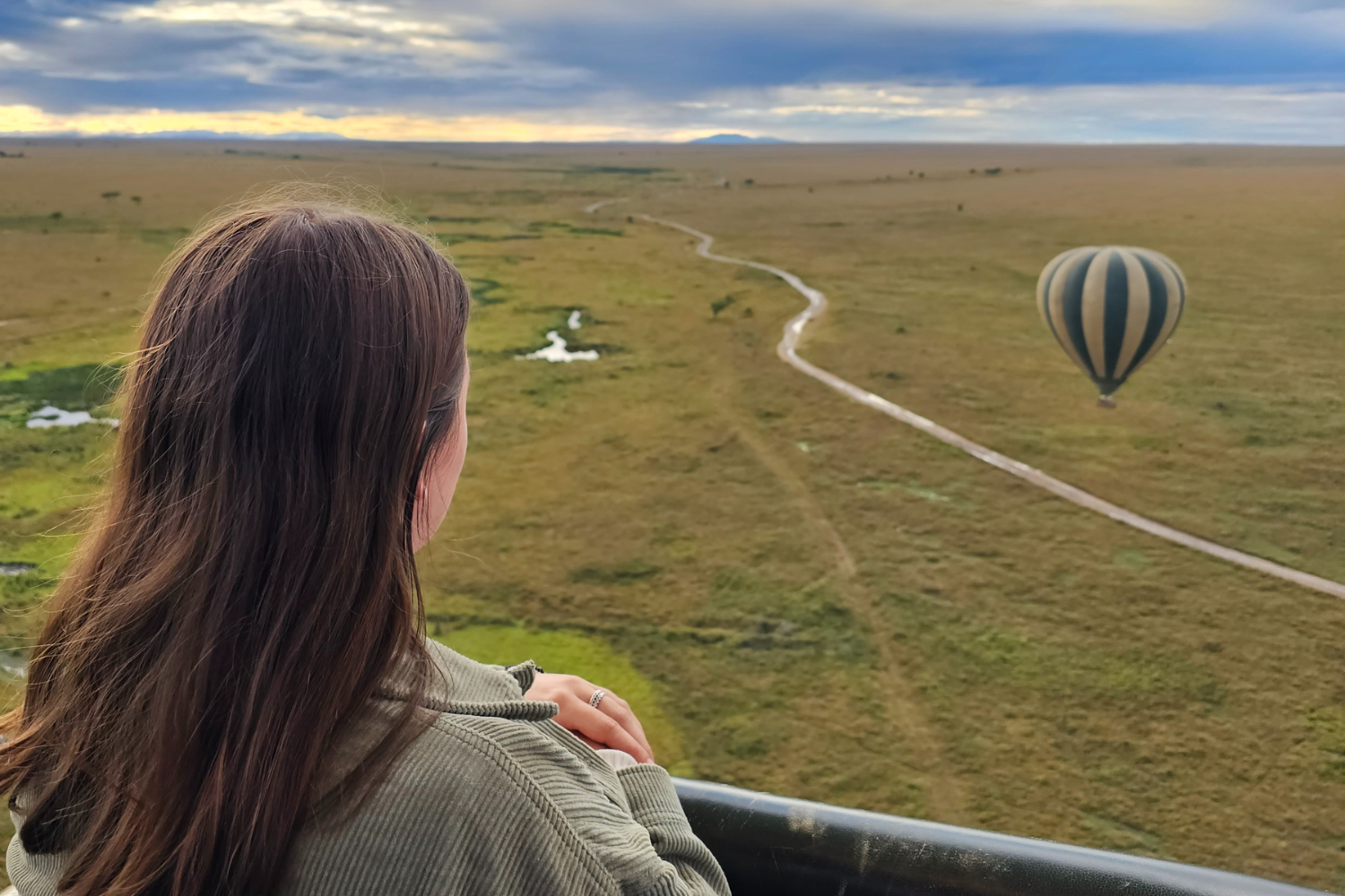 Traveller looking across Serengeti National Park whilst on a hot air balloon ride in Tanzania