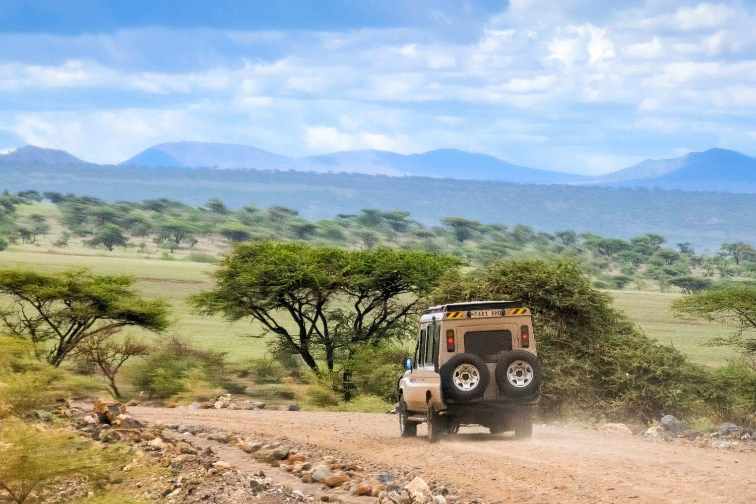 Safari truck driving through Serengeti National Park