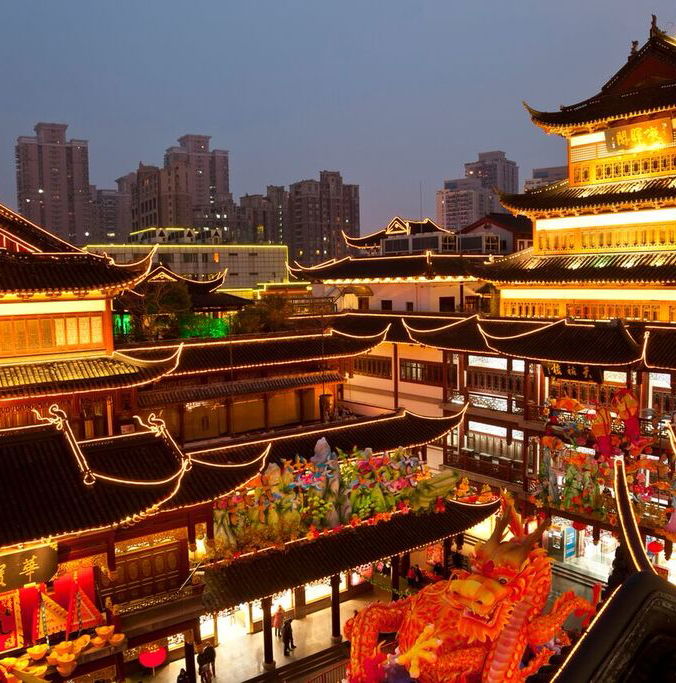 Night view of neon-lit buildings around Shanghai City God Temple