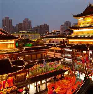 Night view of neon-lit buildings around Shanghai City God Temple