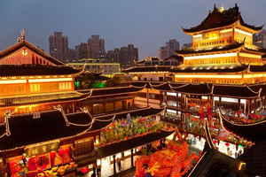 Night view of neon-lit buildings around Shanghai City God Temple