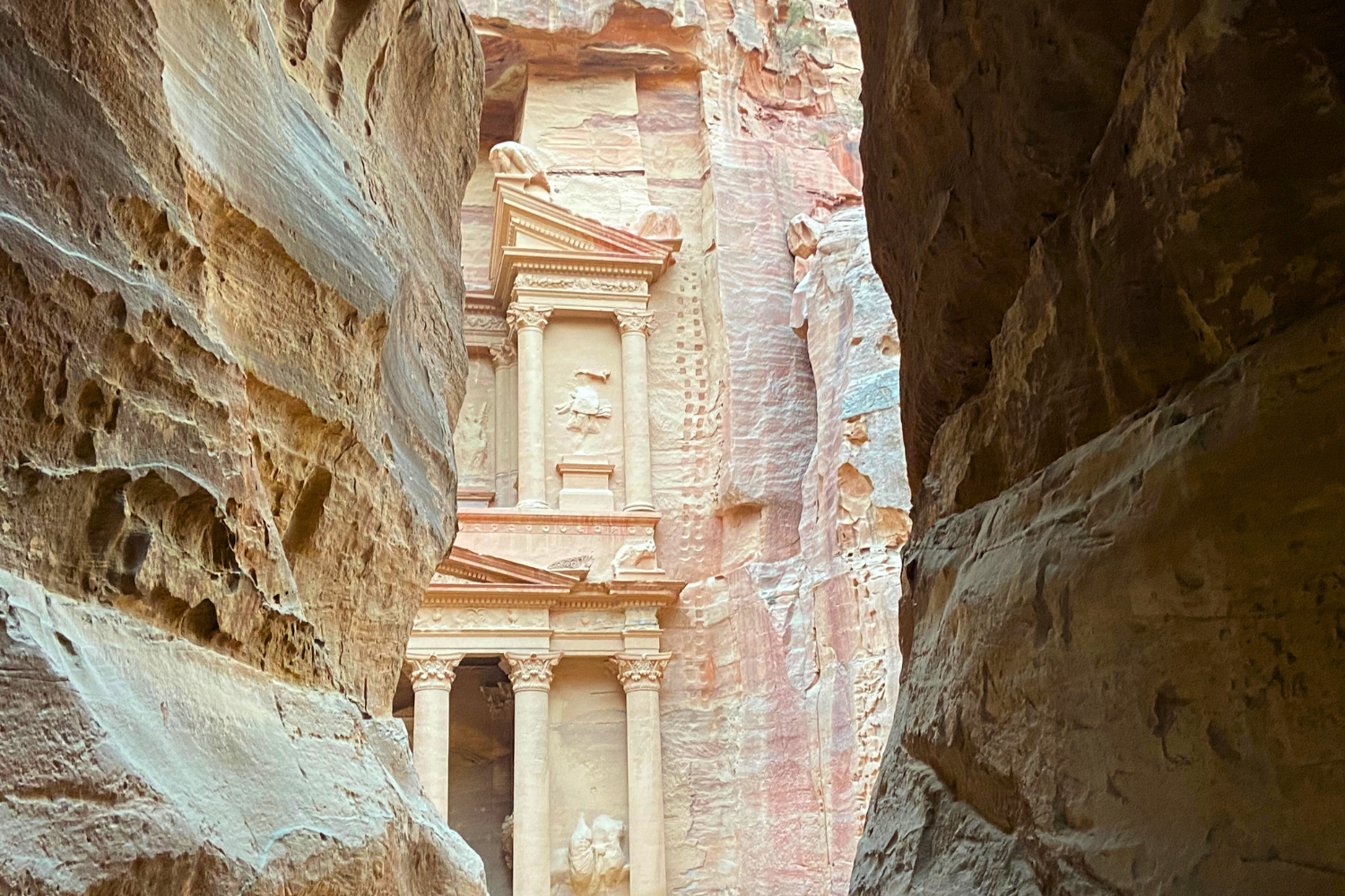 The Treasury in Petra peeking through from the Siq, travellers first glimpse of the wonder of the world