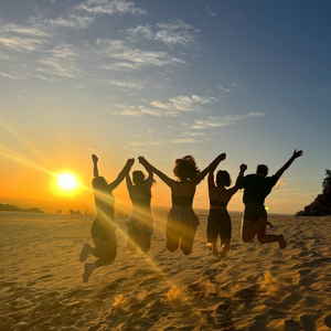 Group jumping on Rainbow Beach, Australia