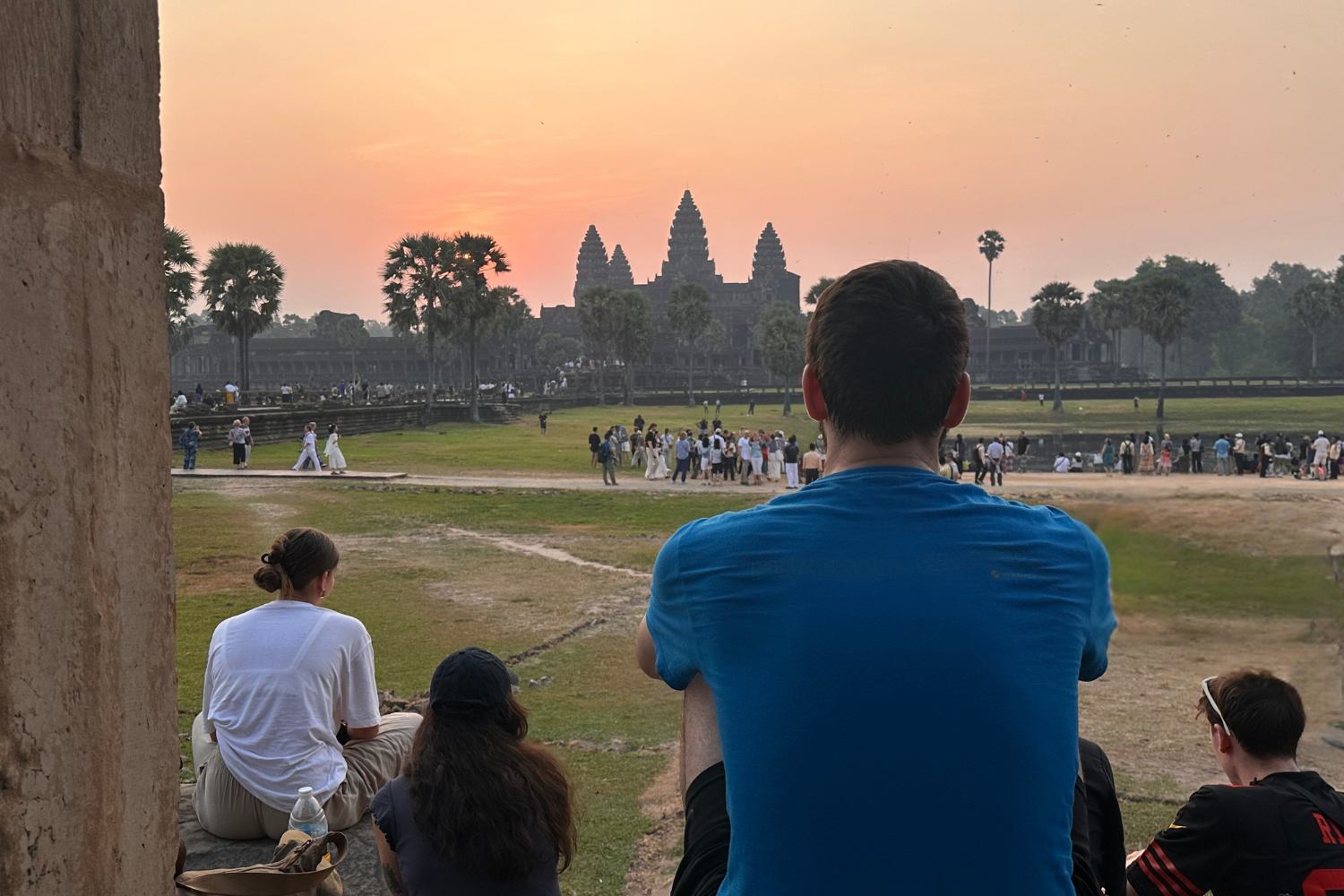 Travellers watching the sunrise over Angkor Wat in Cambodia