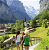 Group of people walking in the Swiss Alps with mountains and cabins