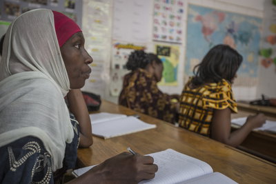 Students in a classroom writing in notebooks