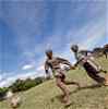 Two Tanzanian schoolchildren playing football
