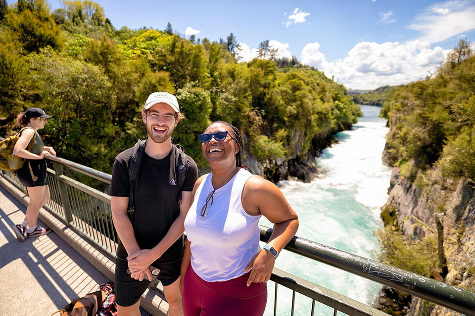Travellers at taupo huka falls in New Zealand