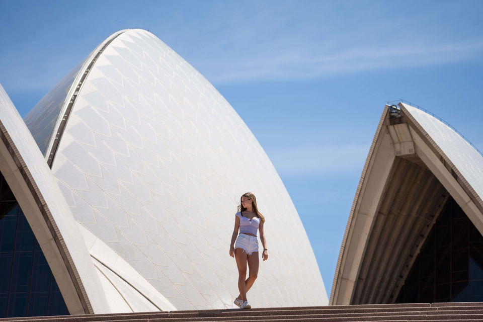 Traveller standing in front of Sydney Opera House in Sydney on group trip