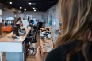 Person looking at barista brochure in Sydney job office