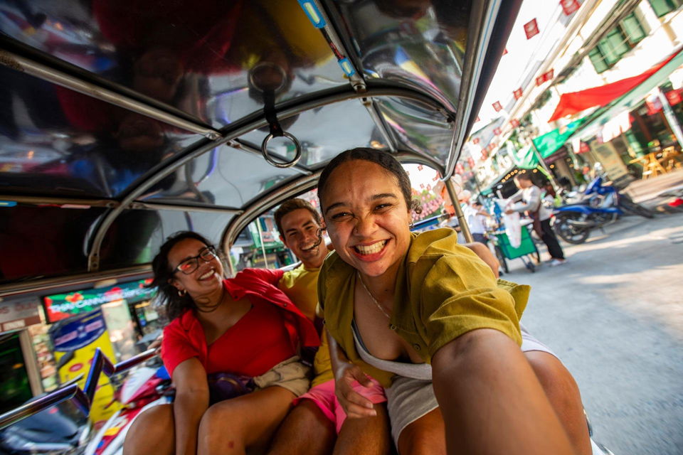 group travellers taking selfie in tuktuk in bangkok thailand